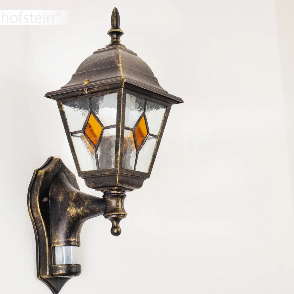 Zewnętrzna lampa ścienna Antibes z czujnikiem ruchu, z odlewu aluminiowego w kolorze brązowym/złotym z przezroczystymi szybami,/podwórko z oprawką E27 w kolorze antycznym, bez żarówek