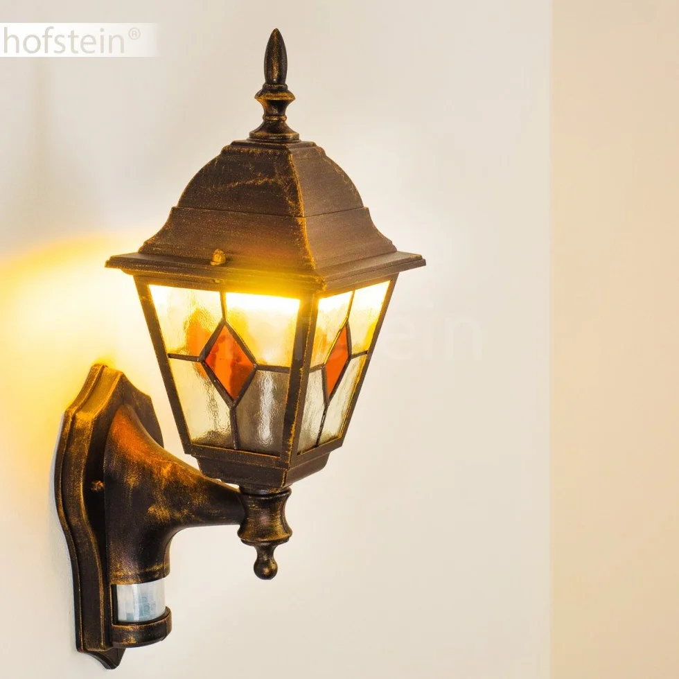 Zewnętrzna lampa ścienna Antibes z czujnikiem ruchu, z odlewu aluminiowego w kolorze brązowym/złotym z przezroczystymi szybami,/podwórko z oprawką E27 w kolorze antycznym, bez żarówek