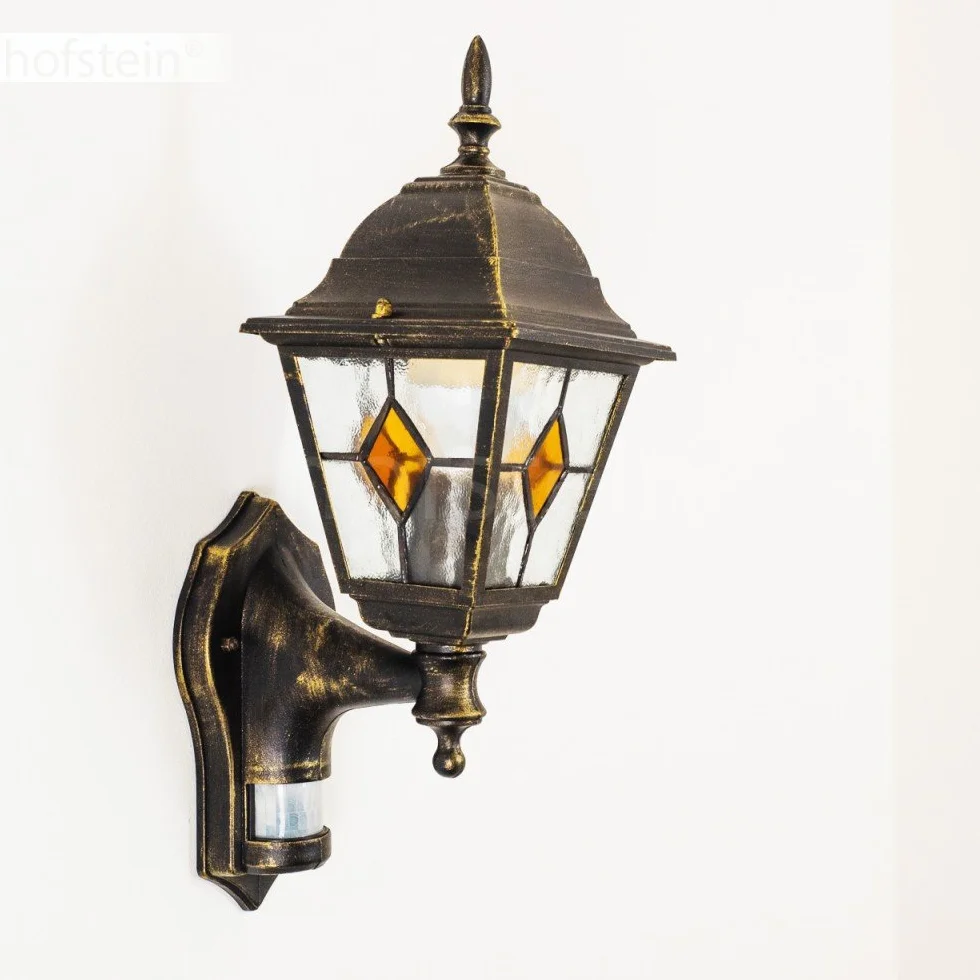 Zewnętrzna lampa ścienna Antibes z czujnikiem ruchu, z odlewu aluminiowego w kolorze brązowym/złotym z przezroczystymi szybami,/podwórko z oprawką E27 w kolorze antycznym, bez żarówek